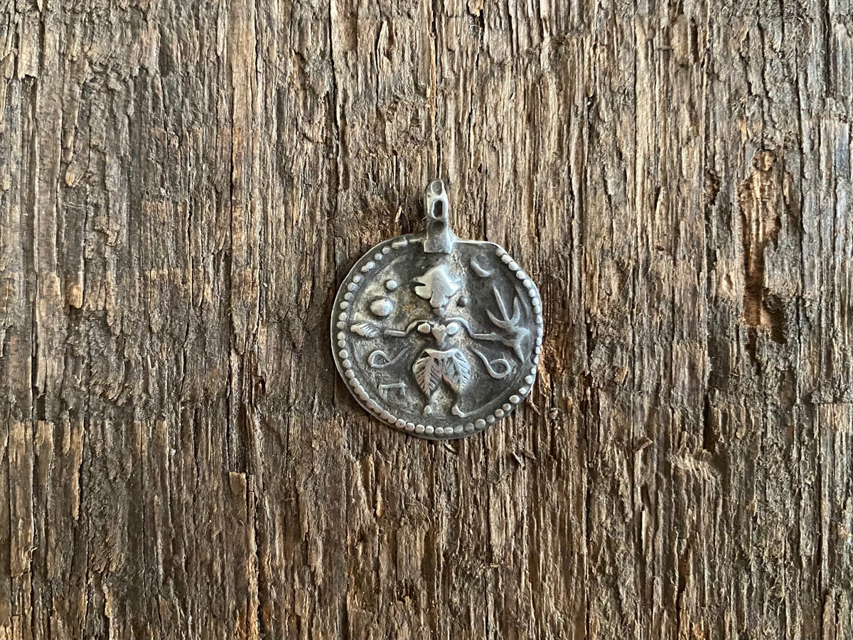 Antique silver amulets representing the Hindu god Kali, in her protective form, and dating from the early 19th - early 20th century.  Measurements: all vary between 1.5 and 2.2 cm in width