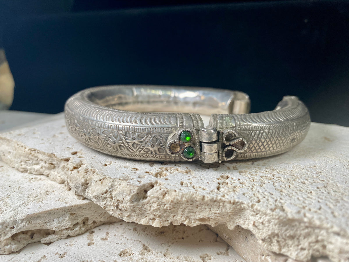 Women's antique tribal anklet, hollow construction, made in a round rigid style with a hinged opening. Very high grade silver, with repeating decoration around all sides and a decorative hinge. From Rajasthan, India. Late 19th century or older.