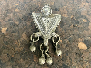 High grade silver pendant, late 19th century, Turkmenistan. It features bands of applied decorative work and a central hammered tree of life design. The pattern is repeated on both sides of the pendant. Length 6 cm
