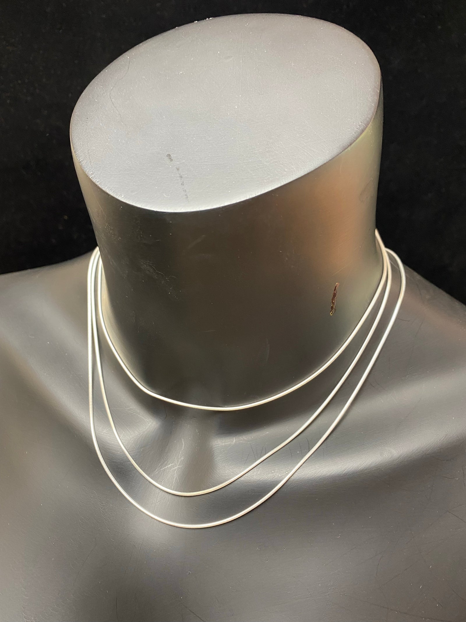 1mm diameter snake chain in three lengths. These nickel-free silver chains are German-made from 93.5% silver and are tarnish-resistant. This fine snake chain features a sturdy parrot clasp and is fitted with a narrow bail to ensure that even the smallest of pendants will fit. Select 40 cm/16", 45cm/18" or 50cm/20"