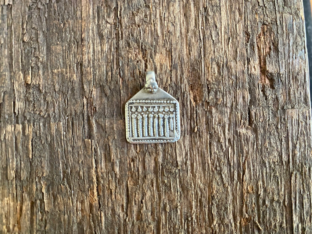 Antique silver amulets representing the Hindu god Skanda and the seven mothers, traditionally worn for protection. Early 19th - early 20th century