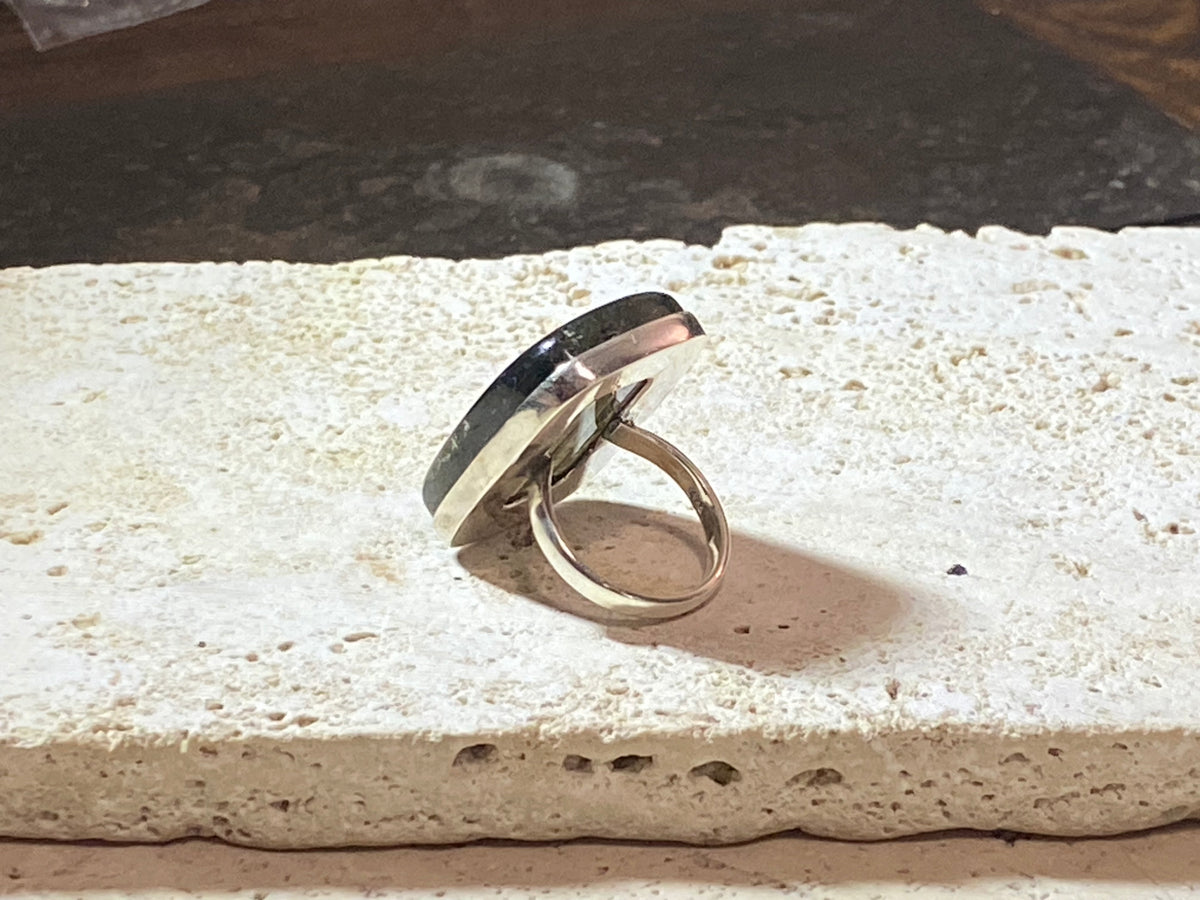 Stunning large rectangular cut labradorite ring set in heavy sterling silver. A high quality stone with a unique striating pattern and excellent colour.  Size 8