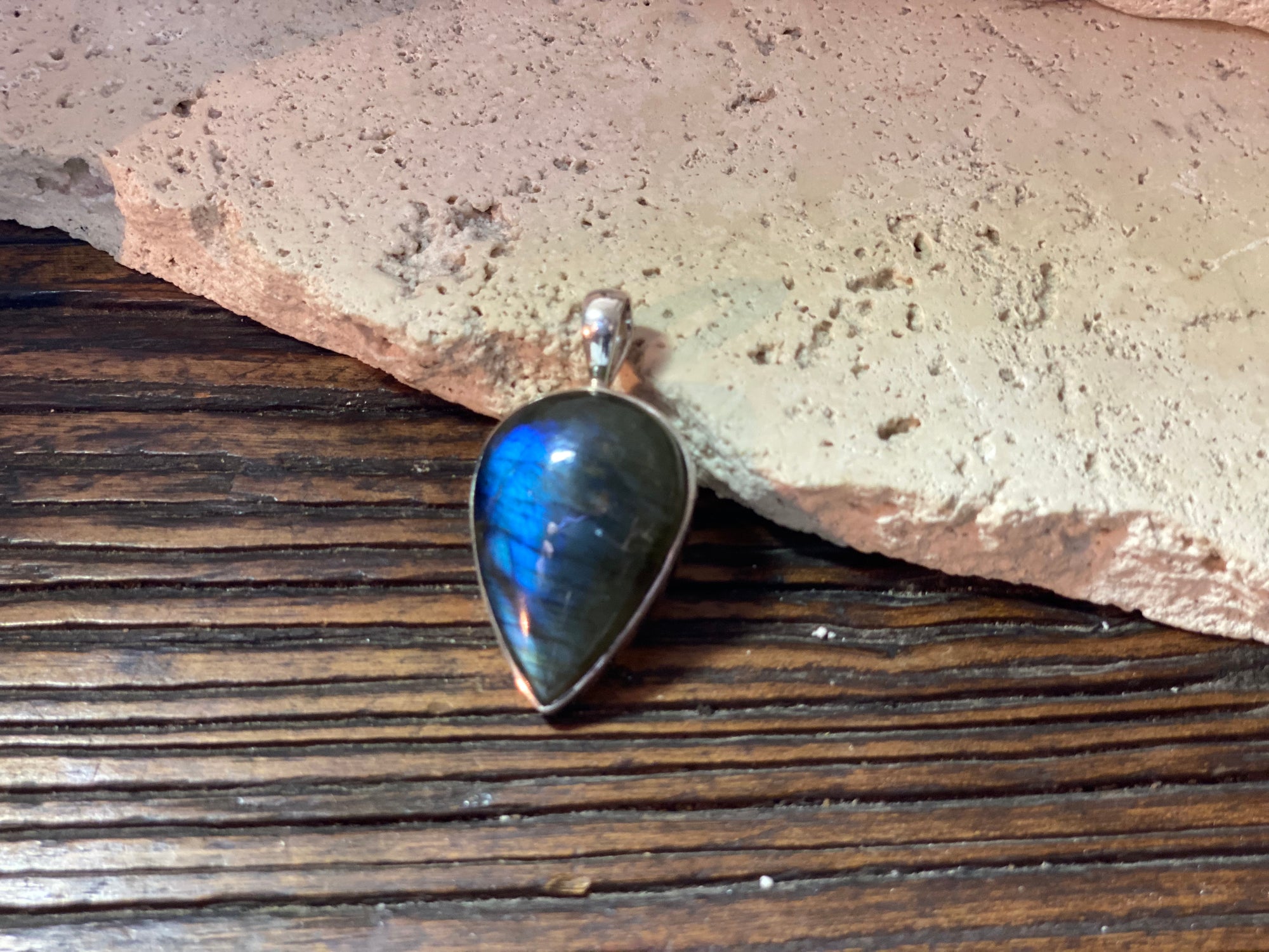 Stunning upside-down teardrop labradorite pendant set in sterling silver with a generous bail to take a large chain or cord. A stunning, high quality stone with excellent blue colour and fire.