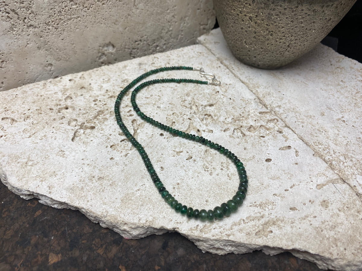 Stunning natural emerald necklace of perfectly drilled and graduated cabochon cut African emeralds finished with a sterling silver hook clasp. Not dyed or heat treated. Premium stringing on jeweller's monofilament. Length 44 cm, 52.6 Ct.
