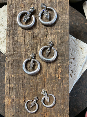 Three pairs of tribal silver earrings called Bent Arrow. Worn pushed sideways through the ear by Yao women. High grade silver, they can only be worn with an extended piercing