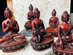 Buddha statues cast from high-quality resin and finished by hand. From a Tibetan artisan exiled in Nepal. Each statue features flowing robes, while free hands cradle the begging bowl.  Each buddha statue is 11 cm