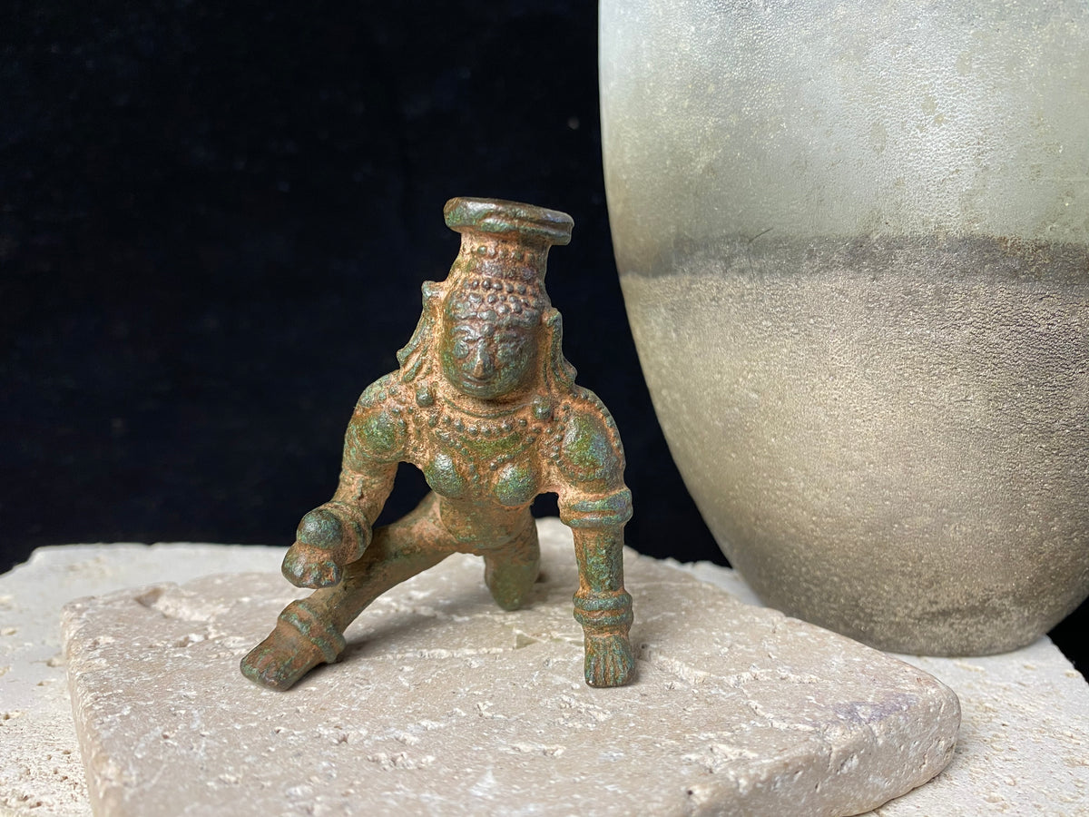 Bal Gopal Krishna. This antique devotional baby Krishna statue is cast from solid bronze, in a crawling posture carrying butter in his hand, 19th century, Orissa Provence, India. This statue has a darkened patina commensurate with its age. Measurements: height 6 cm (2.5"), length 6 cm (2.5")