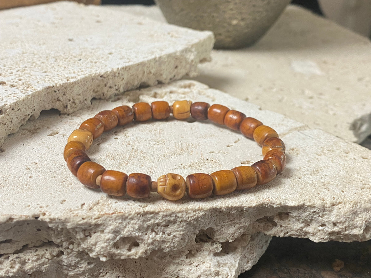 Carved vintage yak bone bead bracelet features carved skull beads and tiny sandalwood spacer beads. Unique and beautiful. Stretchy cord, wear alone or stacked with other bracelets for a classic boho look. Two sizes, 20 cm and 18 cm. Unisex jewellery for men or women.