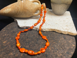 Bold and long red bamboo coral necklace featuring orange-red coral boulder beads of different sizes finished with sterling silver clasp and hook, length 66.5 cm.