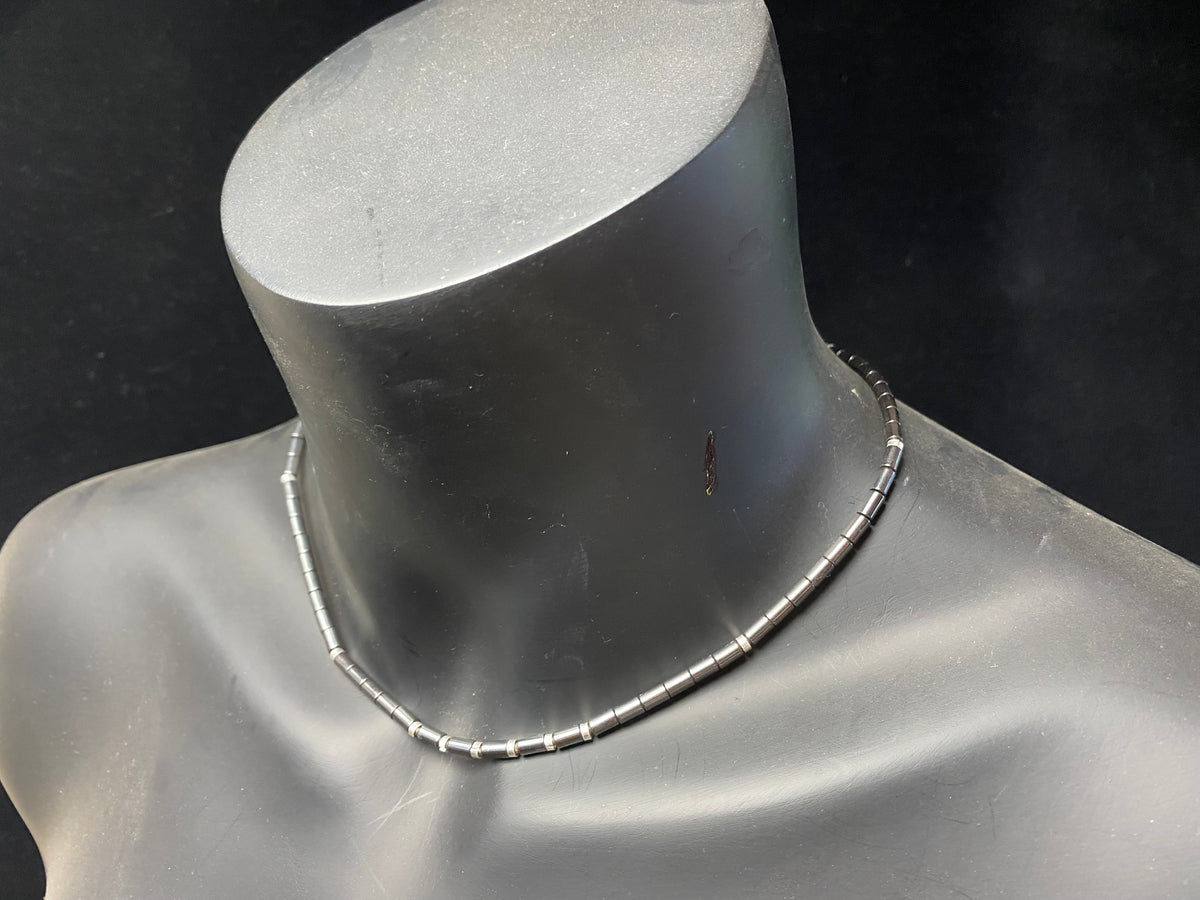 Hematite unisex necklace of tube beads highlighted with sterling silver detailing and finished with a sterling silver hook clasp. Can be worn by men or women.  Natural hematite necklace. Length 44.4 cm (17.5")