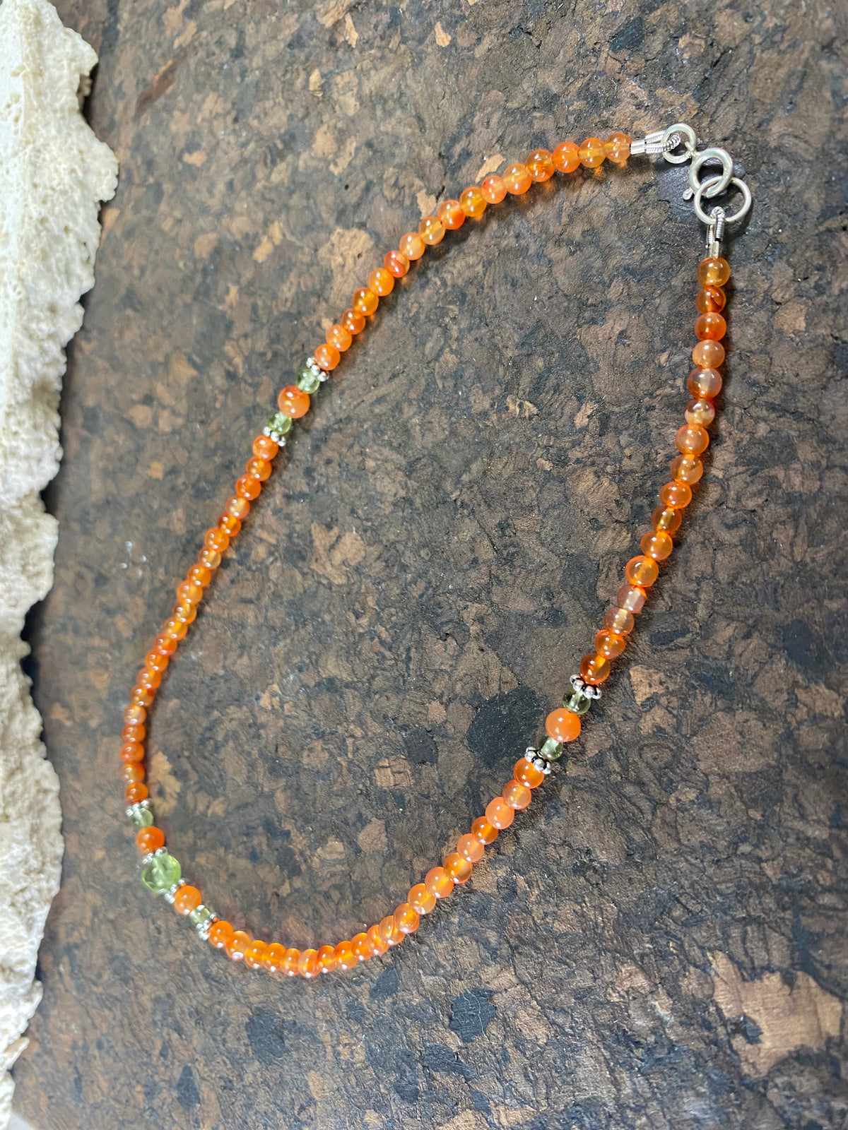 Beautiful anklets featuring natural carnelian, peridot and sterling silver charms. Sterling silver clasps and detailing. Designed to sit gracefully around the foot rather than tight to the ankle. Select from three sizes.