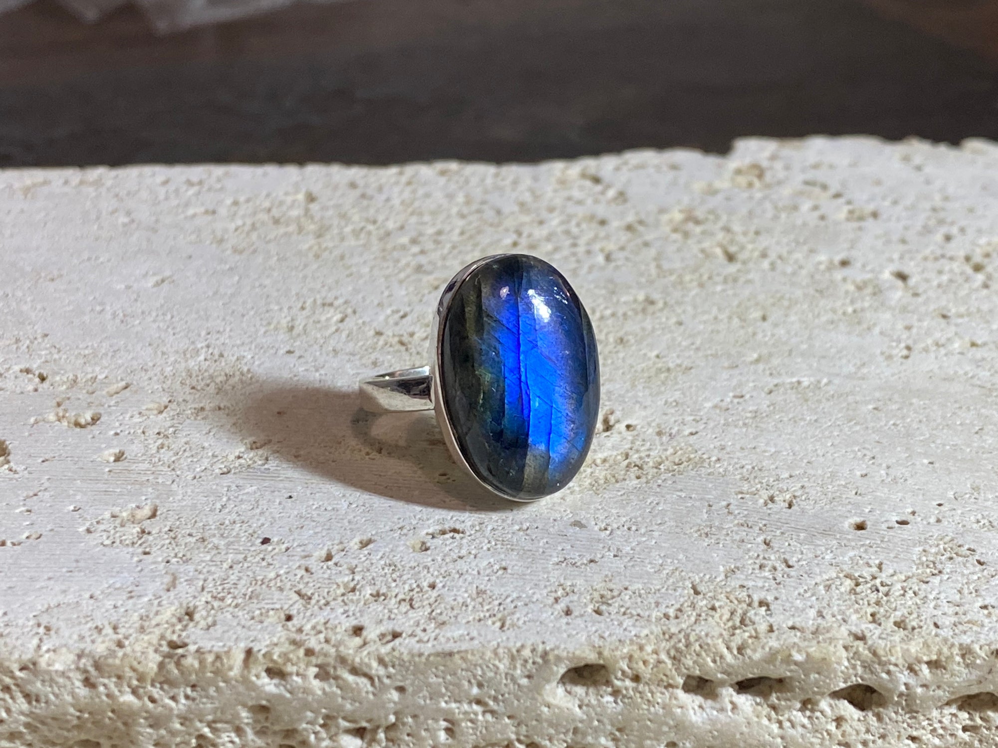 Oval labradorite ring set in heavy sterling silver. A high quality stone with excellent dark blue luminosity and fire.  Size 7.75