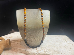 Earthy, rich and natural - our natural tigers eye necklace features pebble cut black agate and sterling silver detailing. This boho necklace is ethnic inspired chic. Length 46.5 cm