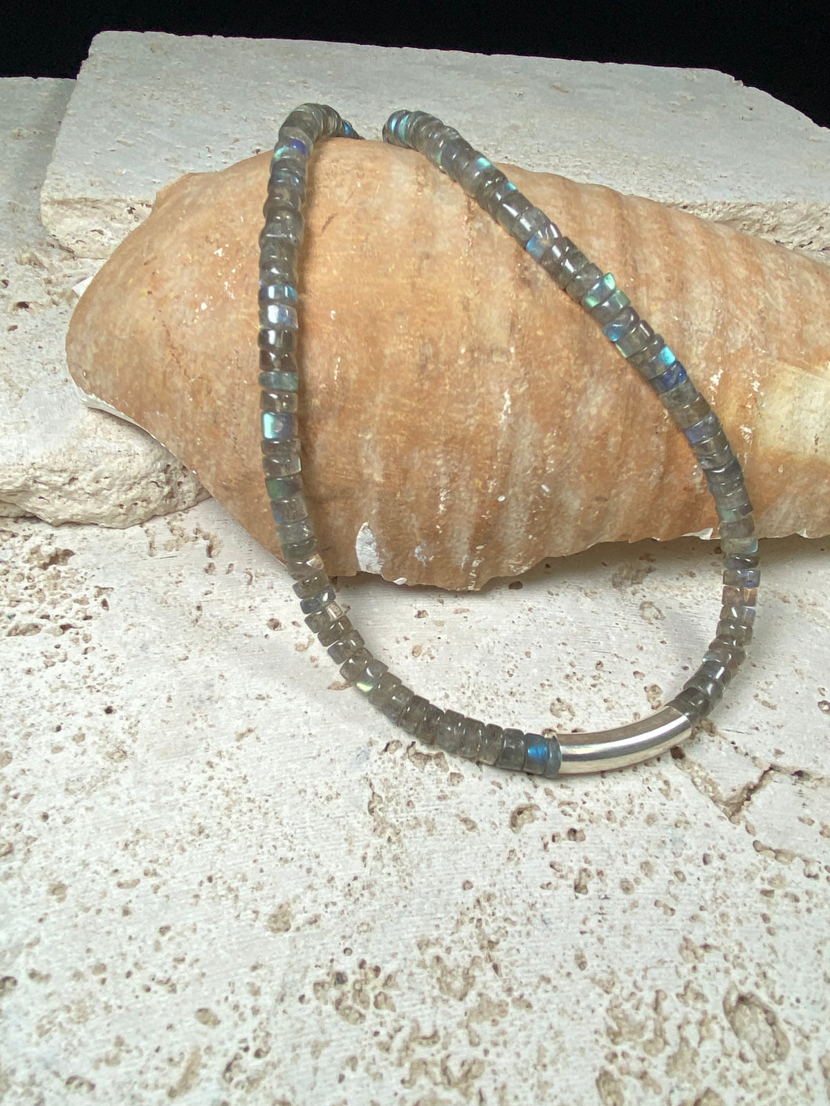Striking choker necklace of rondel-cut labradorite, highlighted with a central sterling silver pendant bead. This necklace is finished with a sterling silver hook clasp. Length 42 cm