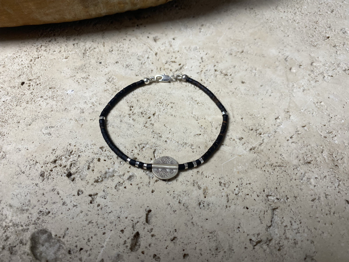 One of our signature coconut silver bracelets, crafted from polished coconut wood and hill tribe 95% silver., with sterling silver lobster clasp. A women's bracelet or a men's bracelet, it has a casual Boho vibe, and is made for that stacked bracelet look. Different sizes available