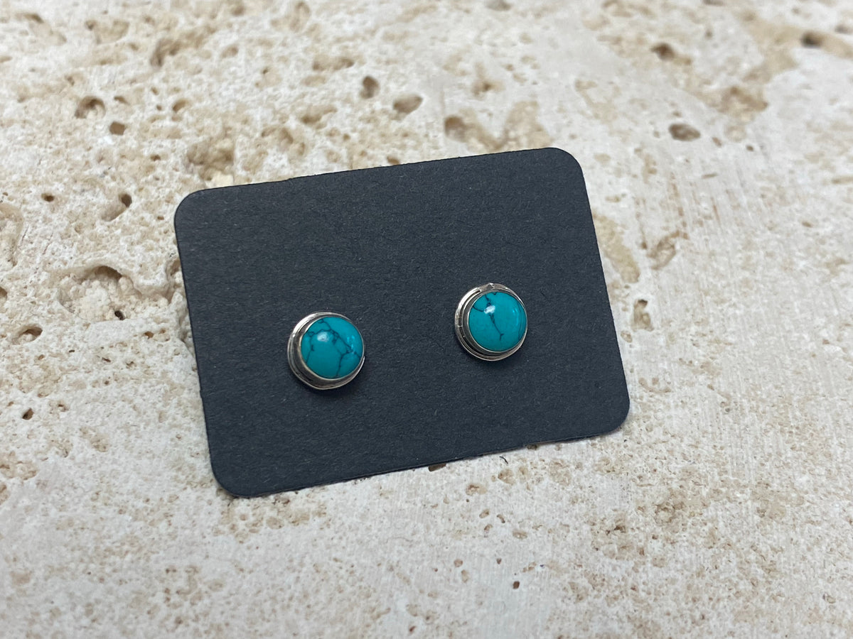 Small natural turquoise earring studs are hand made from sterling silver and set with turquoise cabochons. A unisex earring