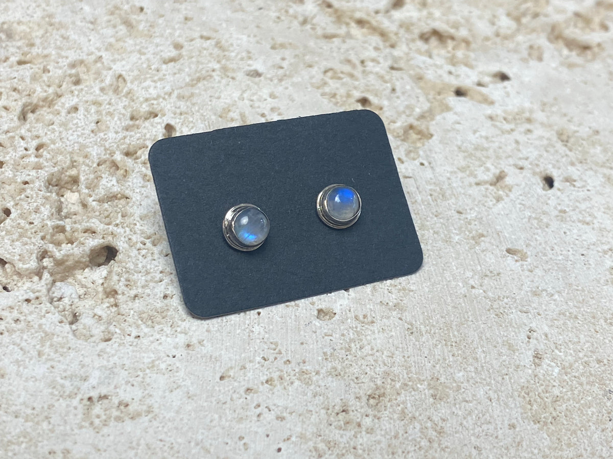 Simple and elegant, these small rainbow moonstone earring studs are hand made from sterling silver and set with natural rainbow moonstone cabochon stones