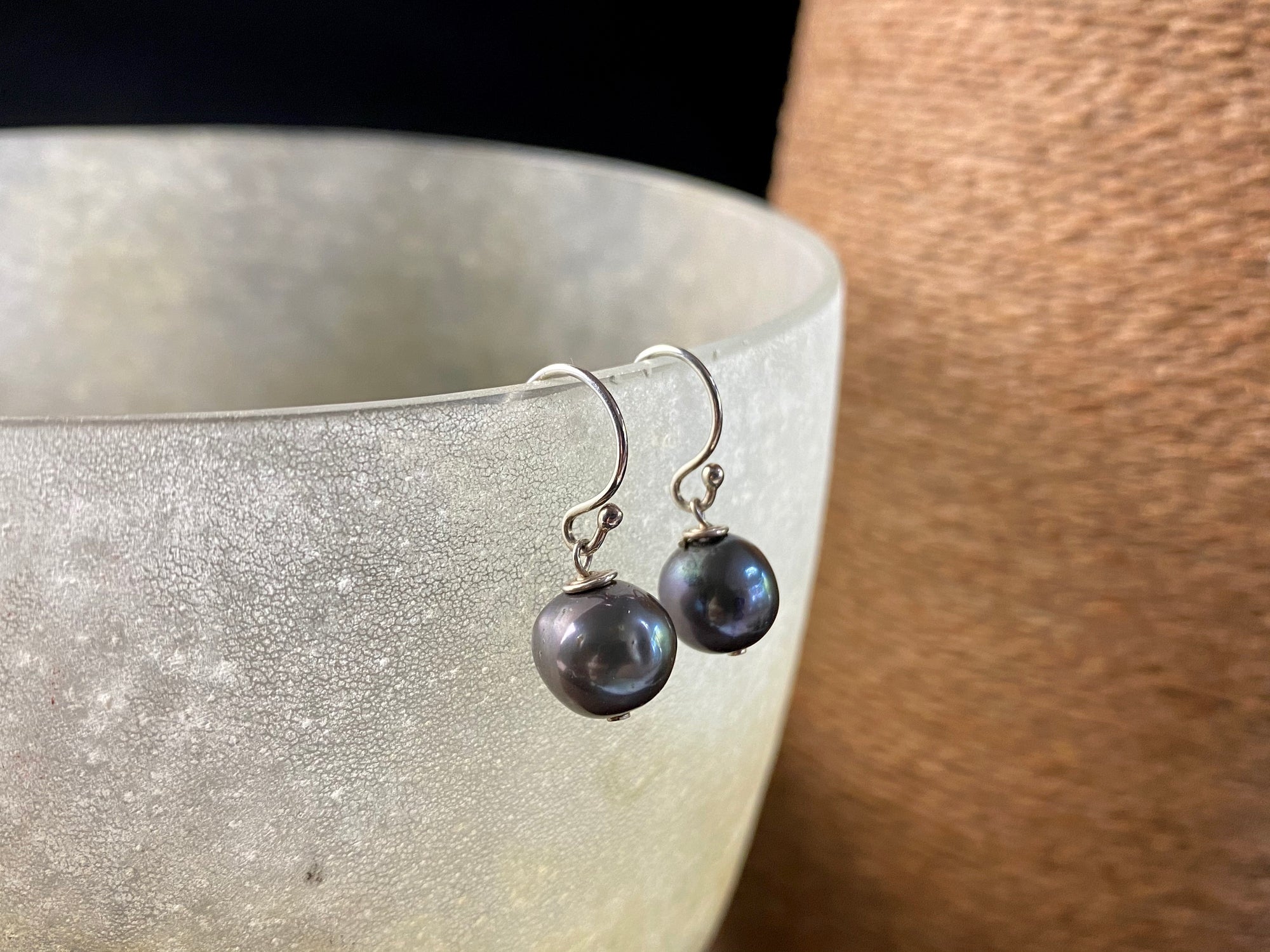 Cultured round black pearl earrings featuring high quality black Burmese pearls 7 mm in diameter and sterling silver hooks