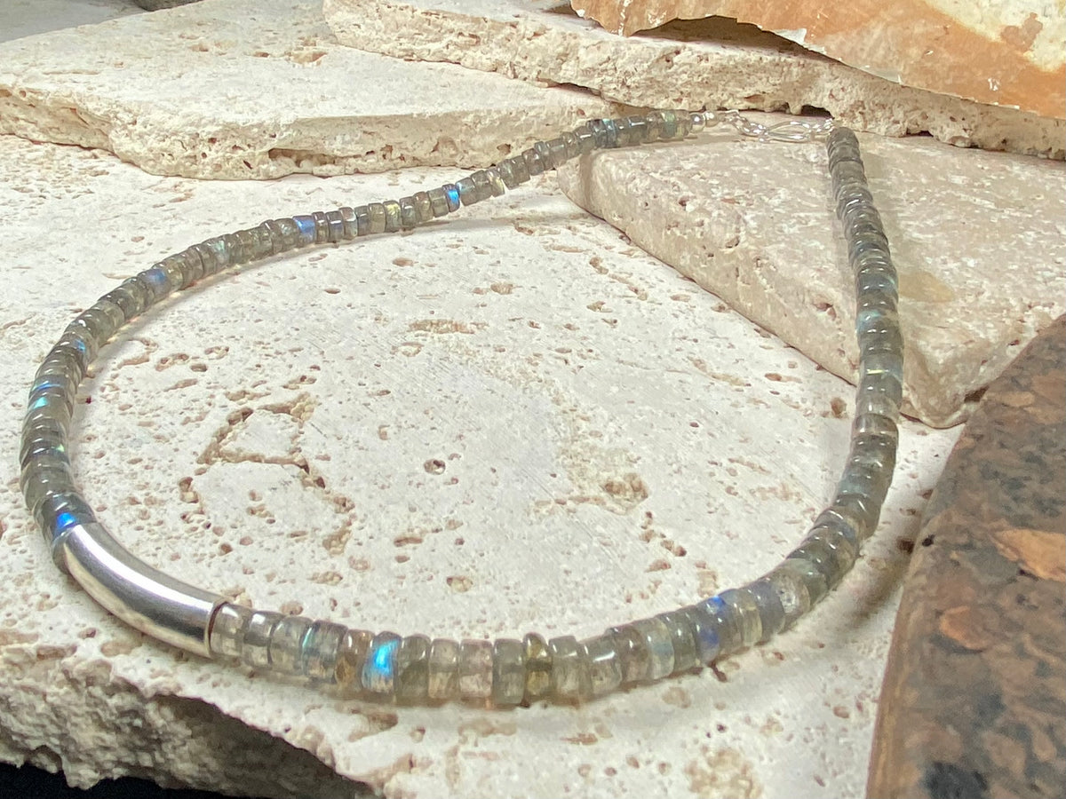 Striking choker necklace of rondel-cut labradorite, highlighted with a central sterling silver pendant bead. This necklace is finished with a sterling silver hook clasp. Length 42 cm