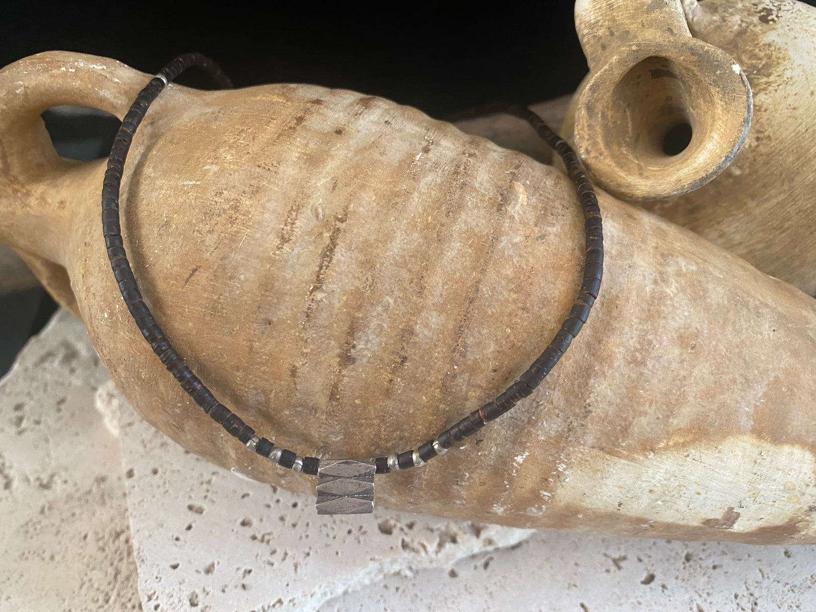 One of our signature coconut silver necklaces, crafted from polished enriched coconut wood, Karen hill tribe 95% silver beads, and a sterling silver clasp. A women's necklace or a men's necklace, it has a casual Boho vibe. Different lengths available