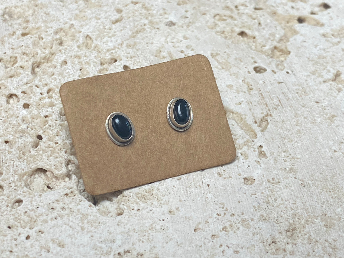 Simple and elegant, these small black onyx earring studs are hand made from sterling silver and set with onyx cabochons