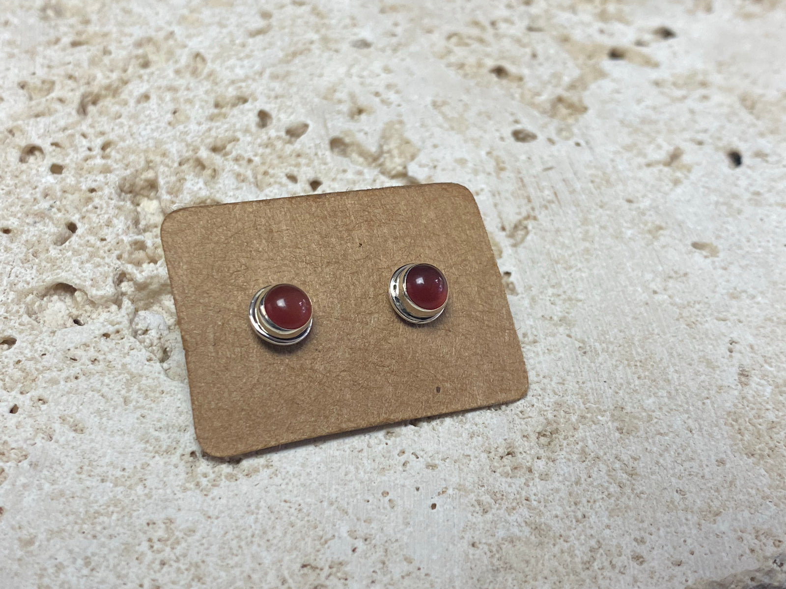 Simple and elegant, these small carnelian earring studs are hand made from sterling silver and set with natural carnelian cabochon stones
