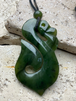 Stunning natural light green veined jade Maori guardian Manaia pendant