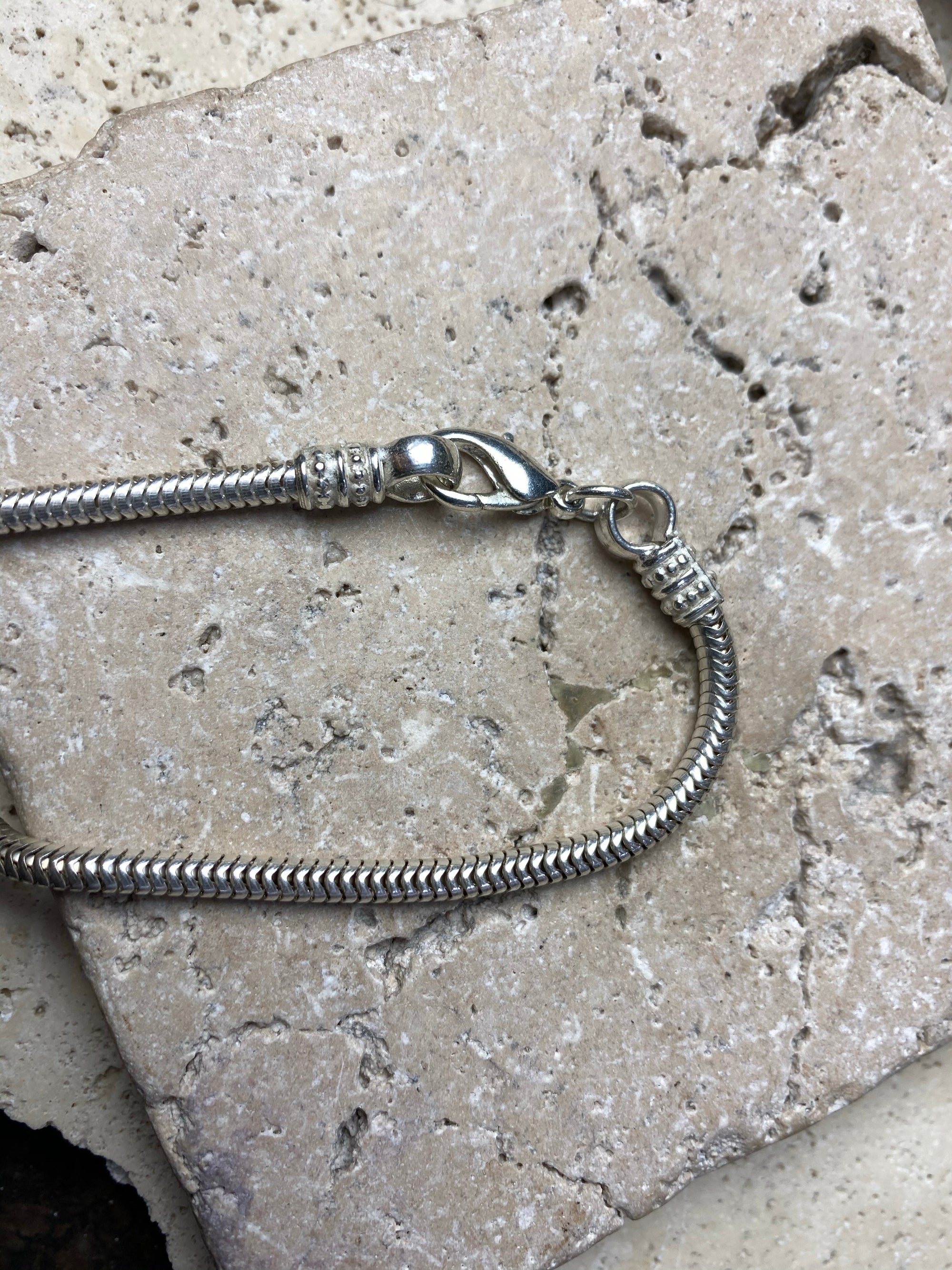 Silver-look open weave snake chain is light and strong, with a bright silver finish and lobster clasp