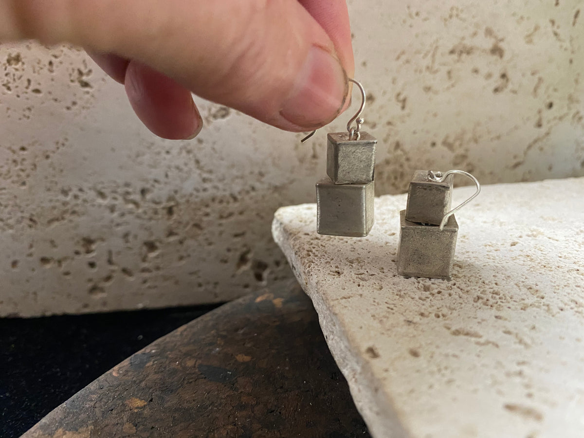 Silver earrings crafted from cubes of matted silver cleverly attached so they can move and swing independently of each other. Fascinating to look at, with a beautiful industrial effect. Length 3.5 cm