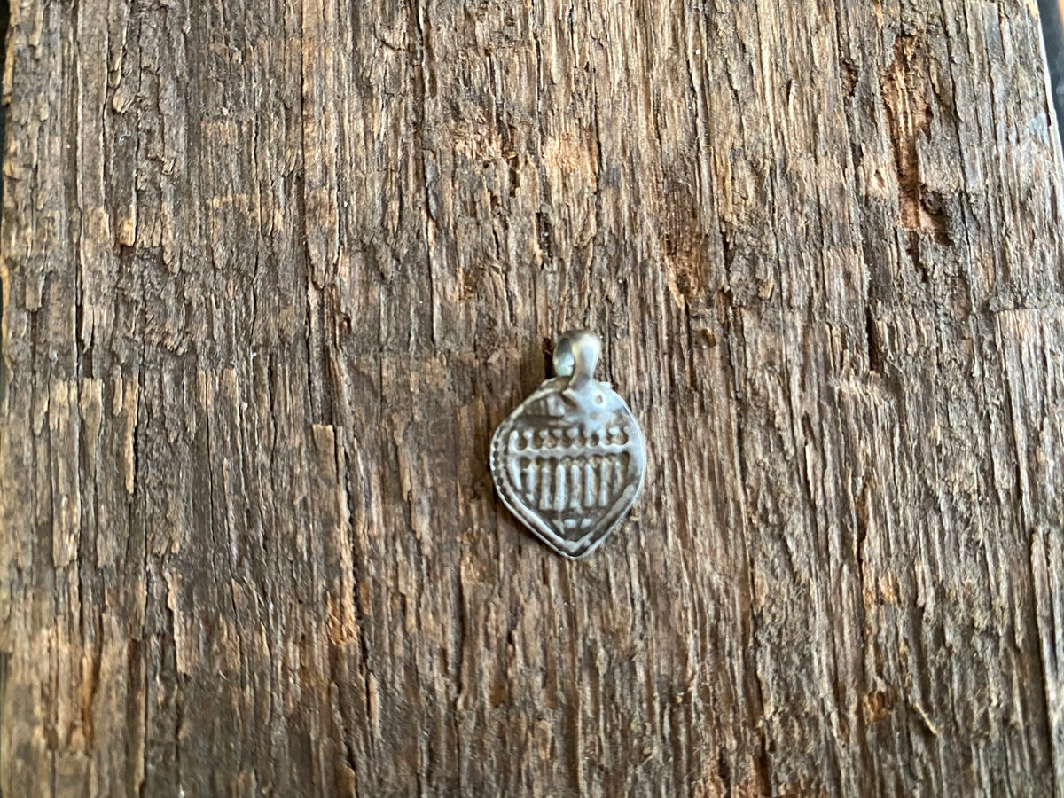 Antique silver amulets representing the Hindu god Skanda and the seven mothers, traditionally worn for protection. Early 19th - early 20th century