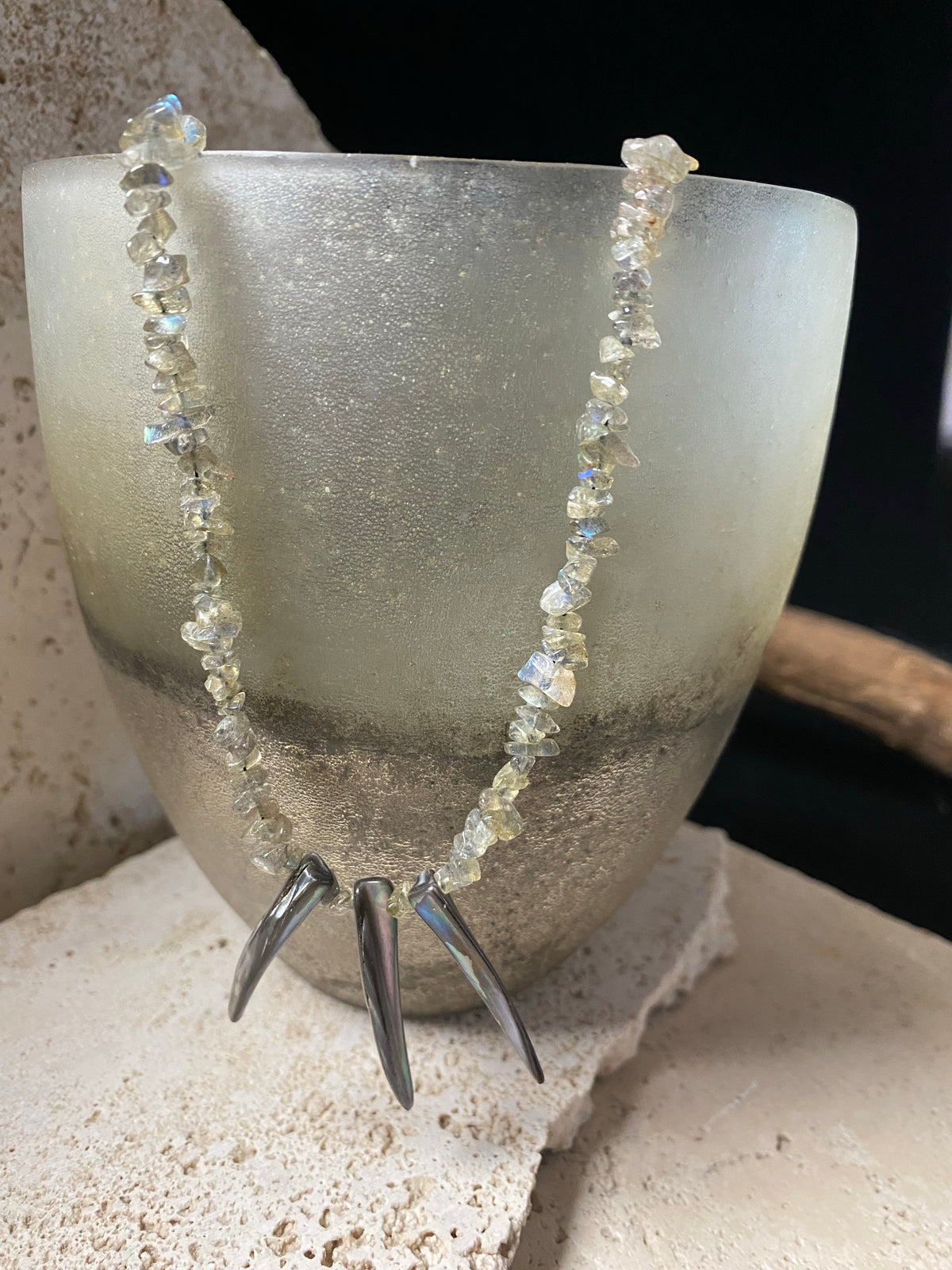 Necklace of rounded labradorite chip stones set with three tribal Pāua pendants designed to highlight the iridescent quality of the natural stone. This necklace is finished with a sterling silver hook clasp. Length 47.7 cm