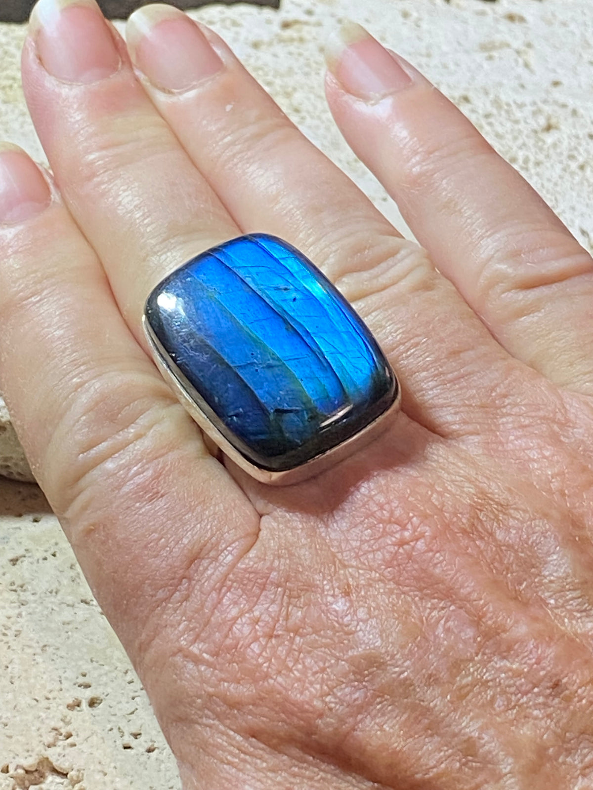 Stunning large rectangular cut labradorite ring set in heavy sterling silver. A high quality stone with a unique striating pattern and excellent colour.  Size 8