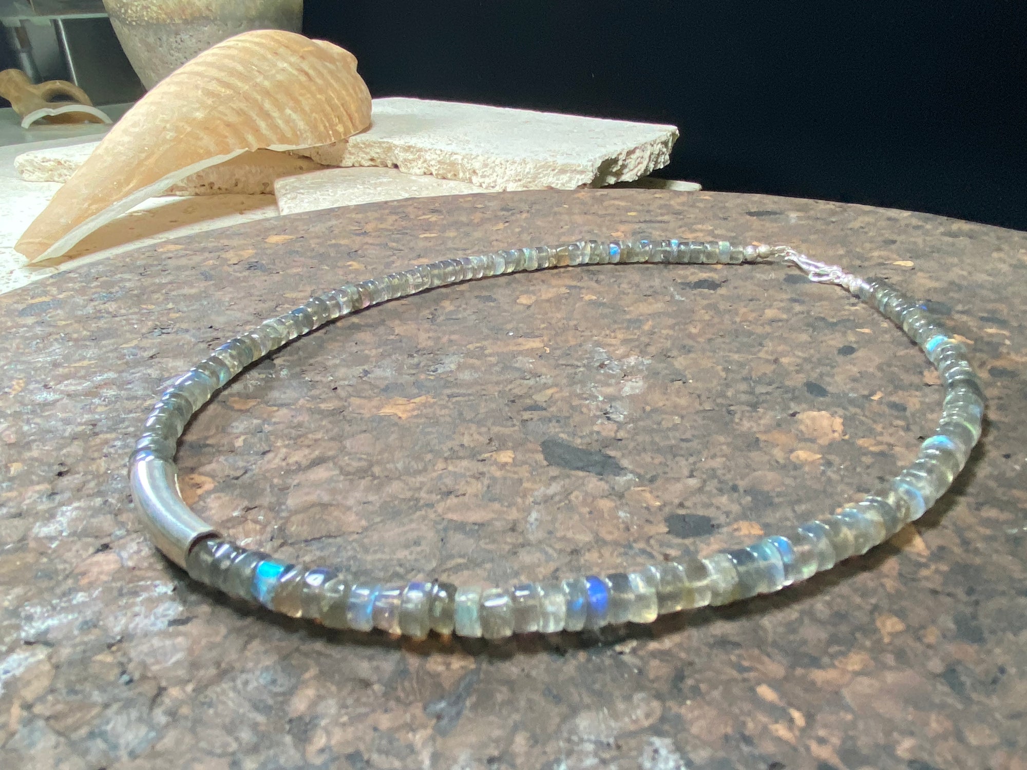 Striking choker necklace of rondel-cut labradorite, highlighted with a central sterling silver pendant bead. This necklace is finished with a sterling silver hook clasp. Length 42 cm
