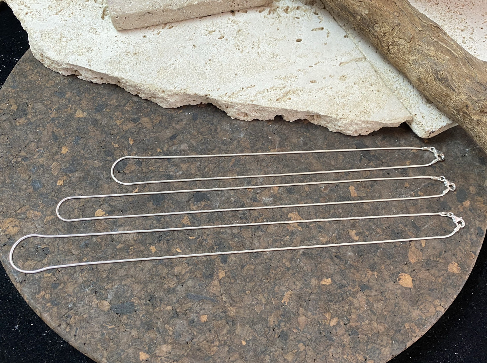 1mm diameter snake chain in three lengths. These nickel-free silver chains are German-made from 93.5% silver and are tarnish-resistant. This fine snake chain features a sturdy parrot clasp and is fitted with a narrow bail to ensure that even the smallest of pendants will fit. Select 40 cm/16", 45cm/18" or 50cm/20"