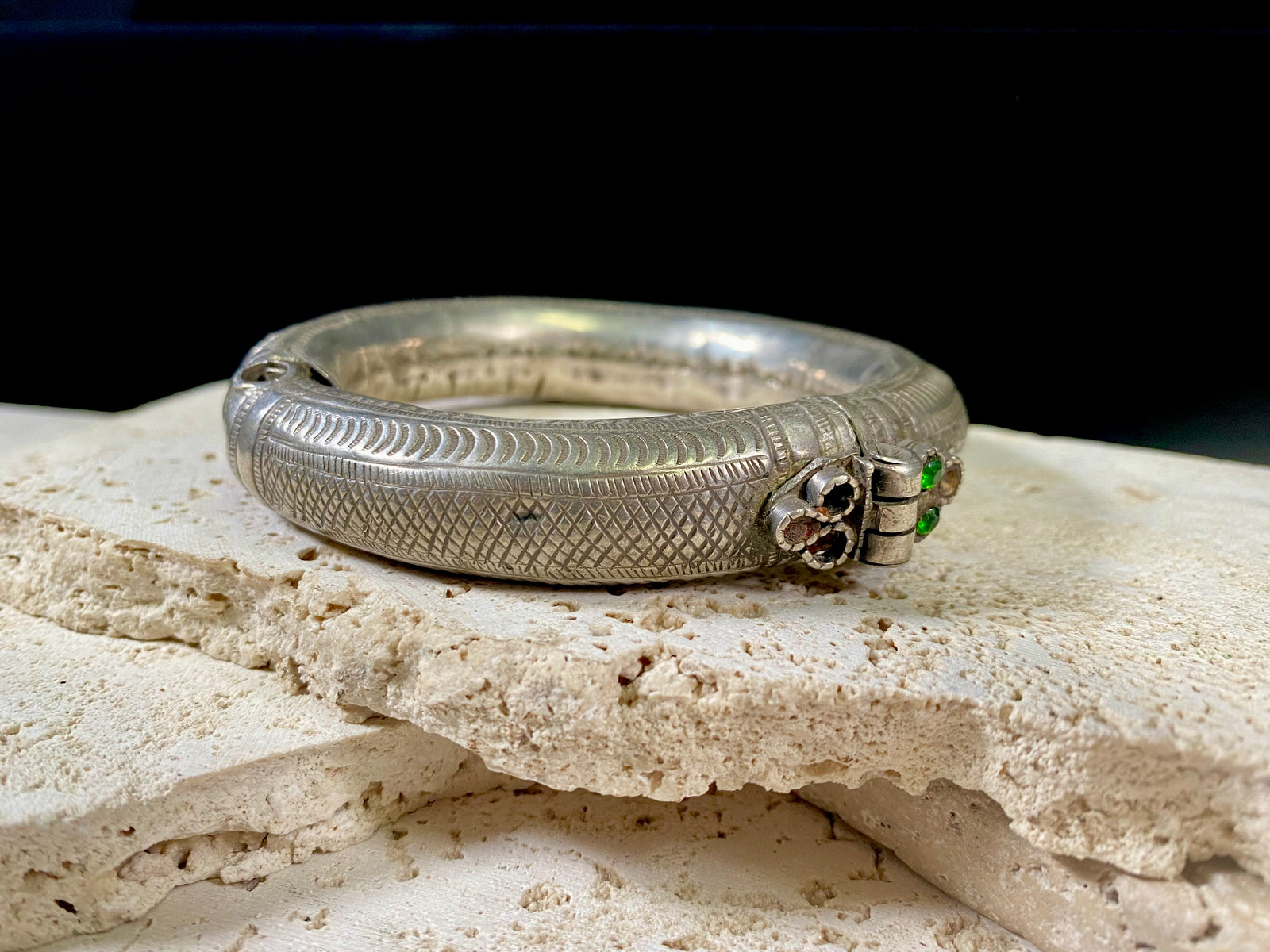 Women's antique tribal anklet, hollow construction, made in a round rigid style with a hinged opening. Very high grade silver, with repeating decoration around all sides and a decorative hinge. From Rajasthan, India. Late 19th century or older.