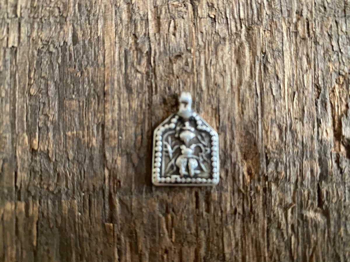 Antique silver amulets representing the Hindu god Kali, in her protective form, and dating from the early 19th - early 20th century.  Measurements: all vary between 1.5 and 2.2 cm in width