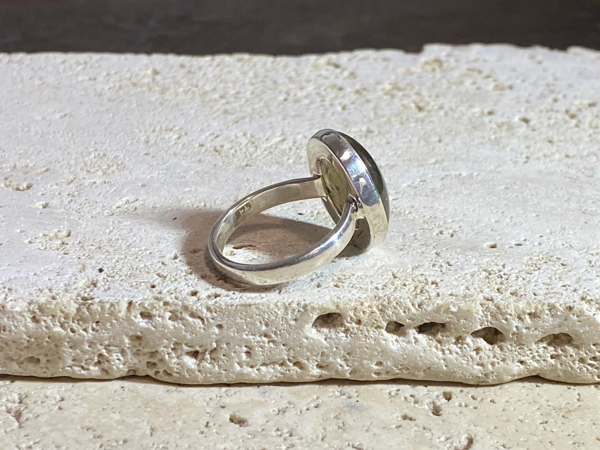 Round oval labradorite ring set in sterling silver. A high quality stone with green, blue and orange fire.  Size 7.5