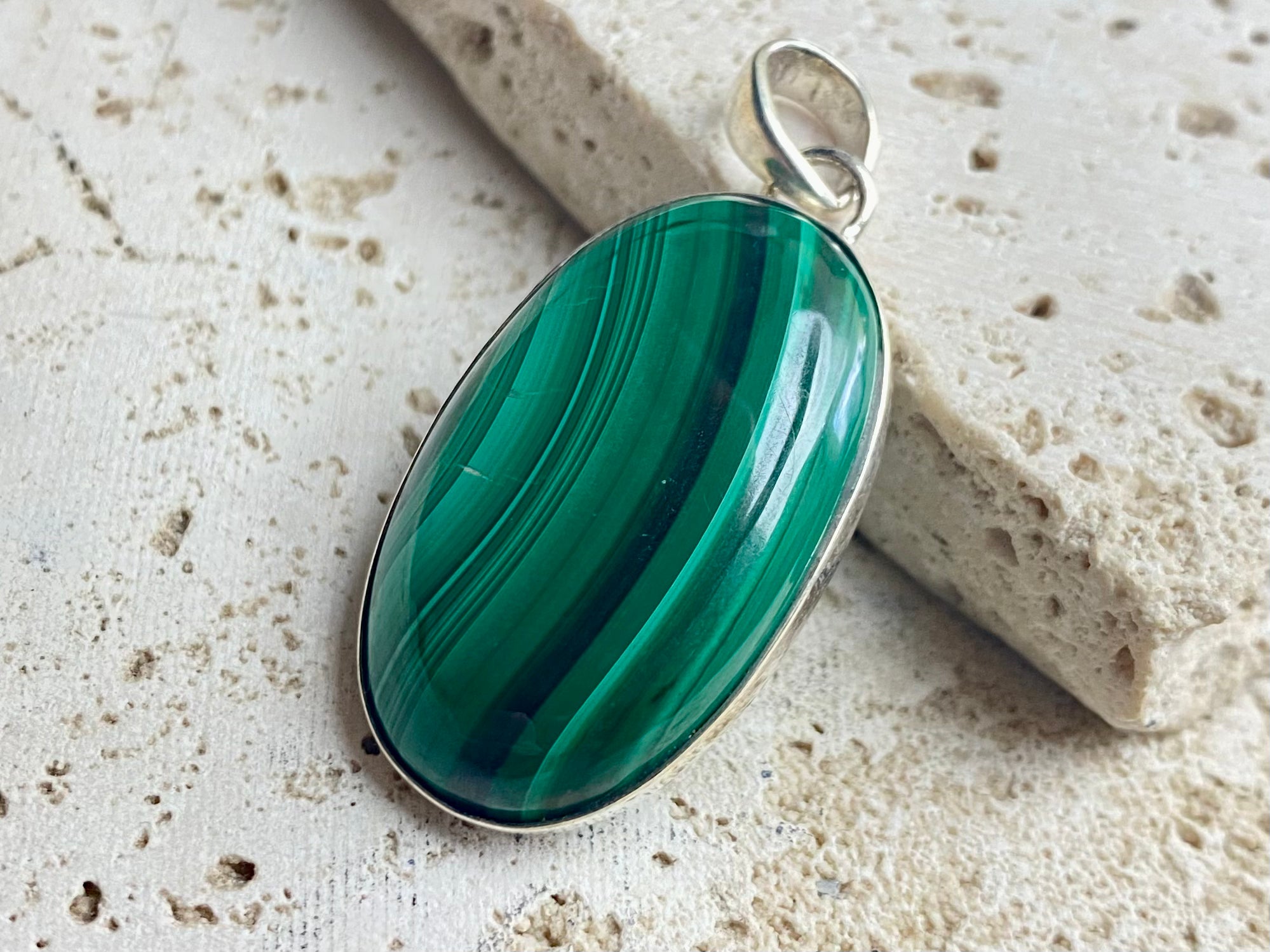 Oval malachite stone pendant set in sterling silver bezel surround, and large bail