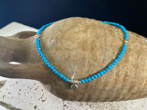 Beach boho anklets featuring turquoise-look dyed howlite and sterling silver charms. Sterling silver clasps and detailing. Designed to sit gracefully around the foot rather than tight to the ankle. Select from three sizes and two styles