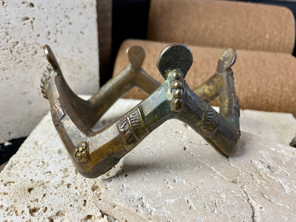 antique upper arm cuff or bracelet, depicting 4 pairs of decorated and bejewelled female arms and hands clasping mirrors. Cast bronze, in excellent condition, showing wear to the inside and underside surfaces
