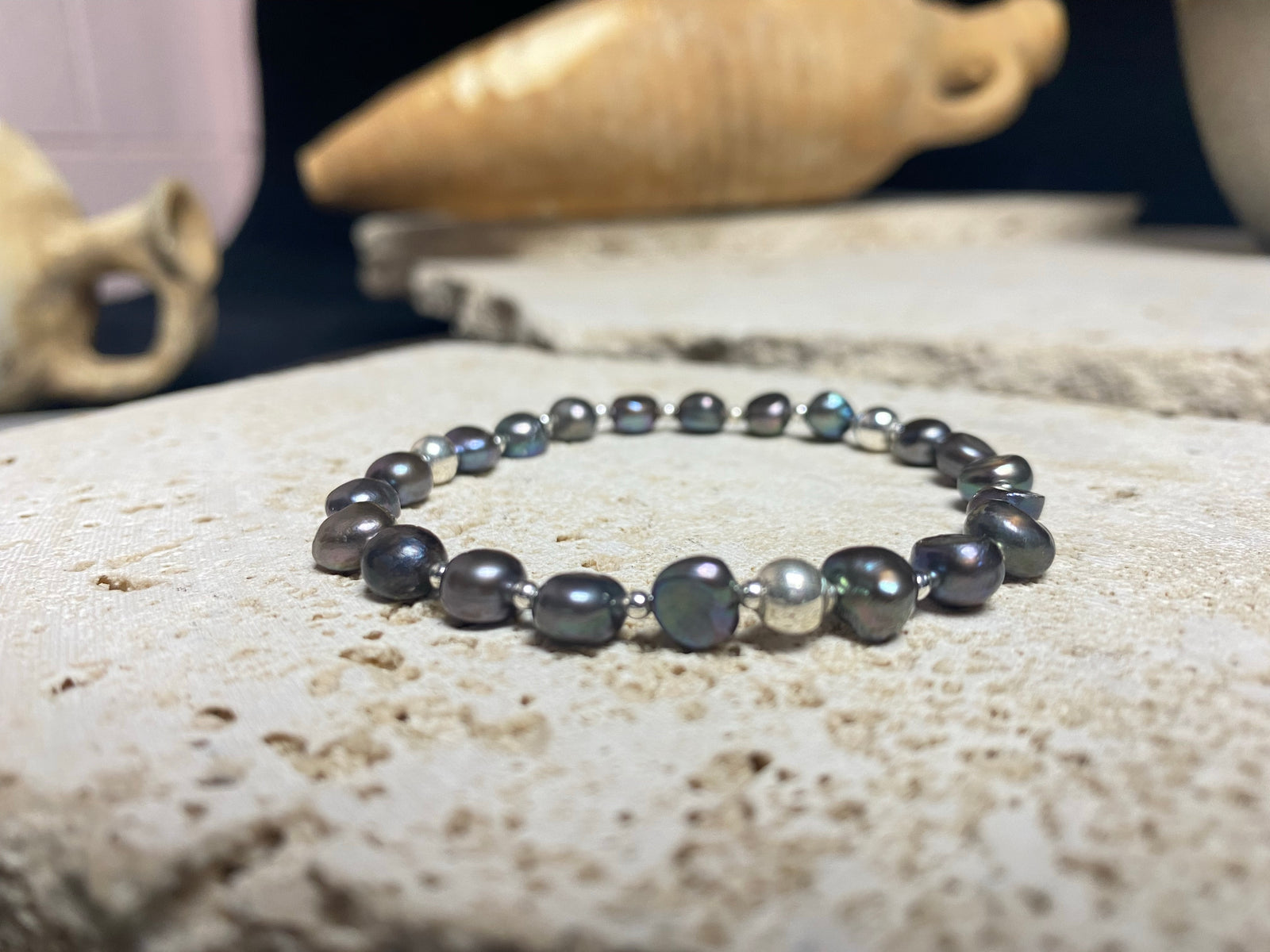 Grey black freshwater pearl bracelet with sterling silver bead detailing. Elasticised stringing for a seamless look. Length 19 cm