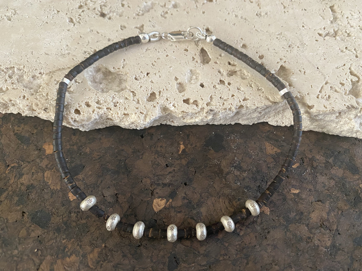 Coconut wood and silver bracelet. Suitable for men or women, our signature bracelet is made from enriched cocnut wood and 95% silver beads. Select from different lengths.