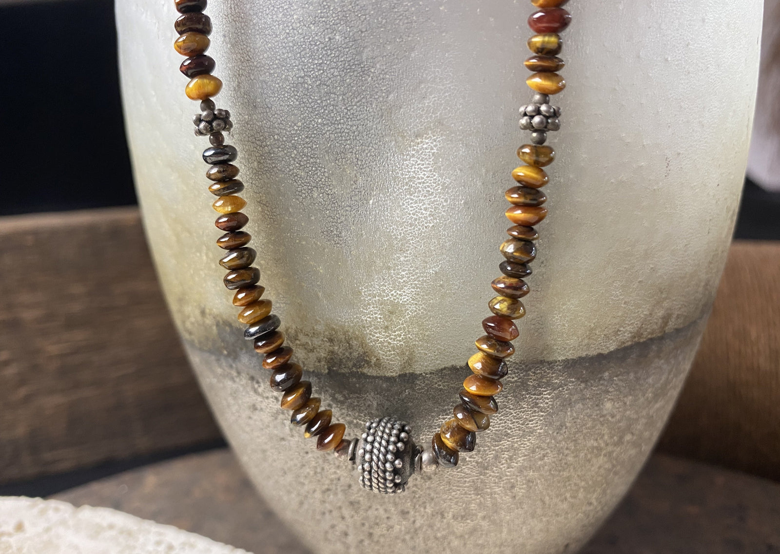 graduated natural tigers eye necklace features a central handmade vintage Indian silver bead and sterling silver detailing