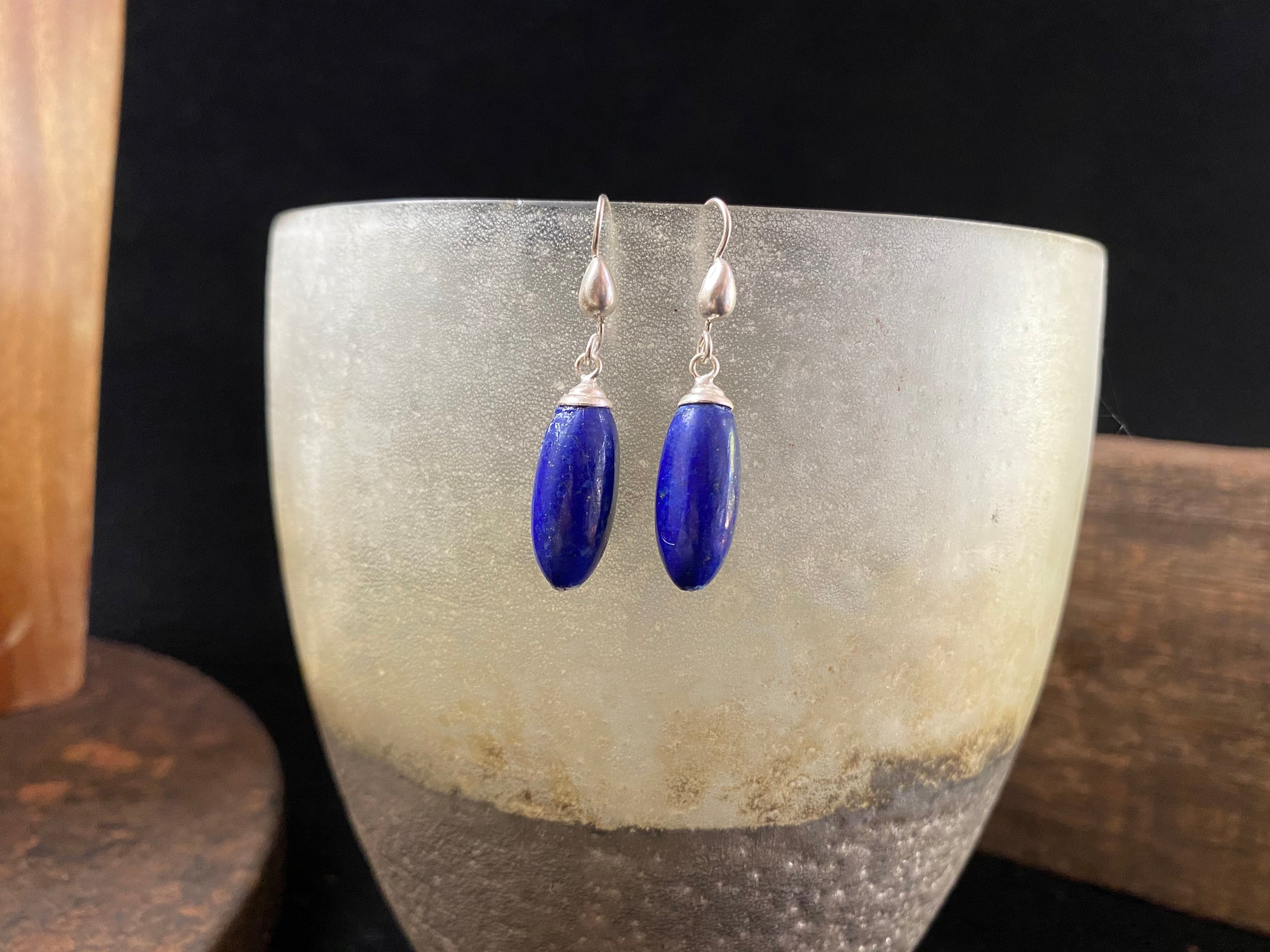 Lapis lazuli natural bead earrings with sterling silver mounts and hooks, finished with small silver beads at the base. and