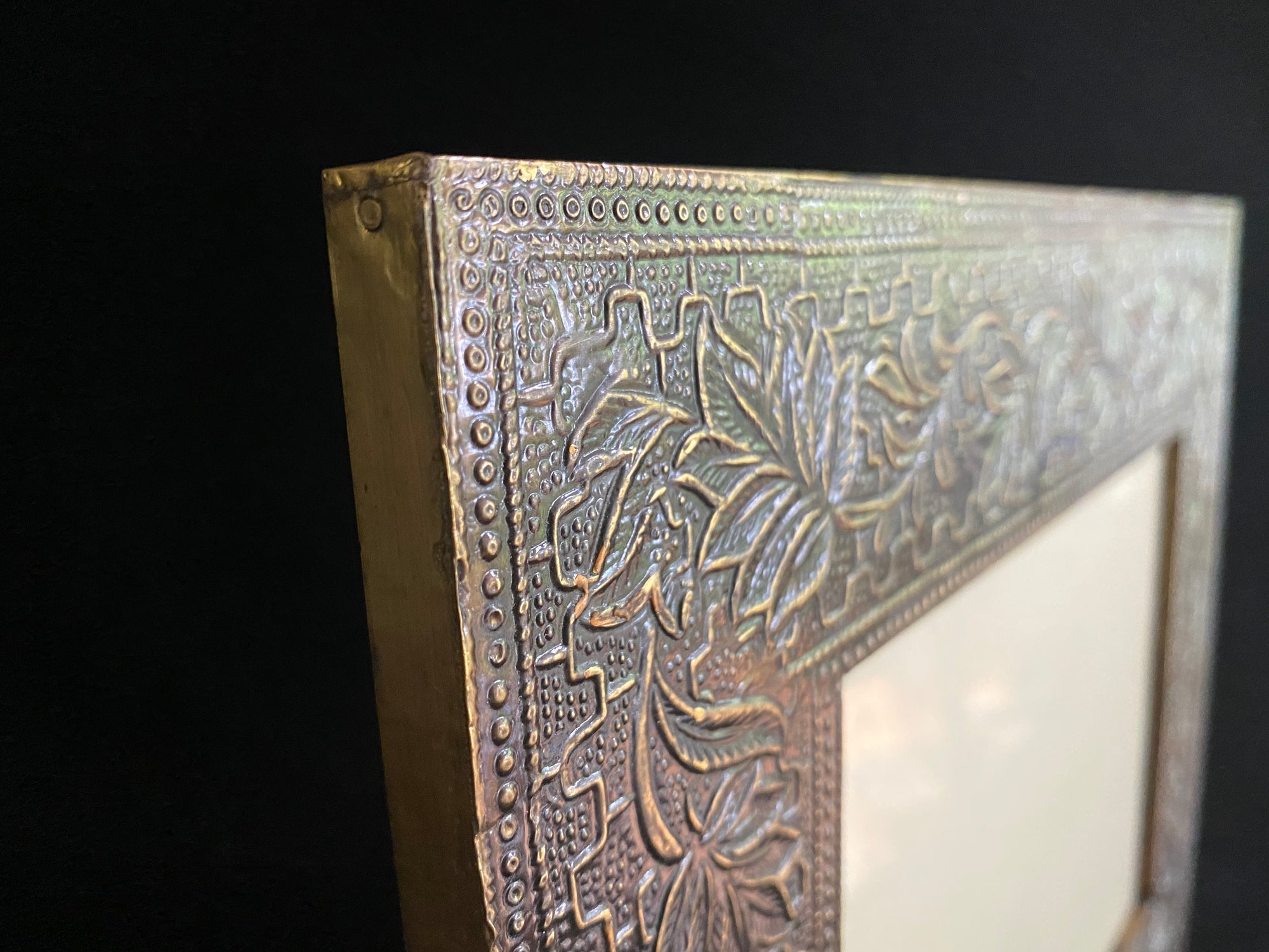 Photo frame features patterned brass over a hardwood frame