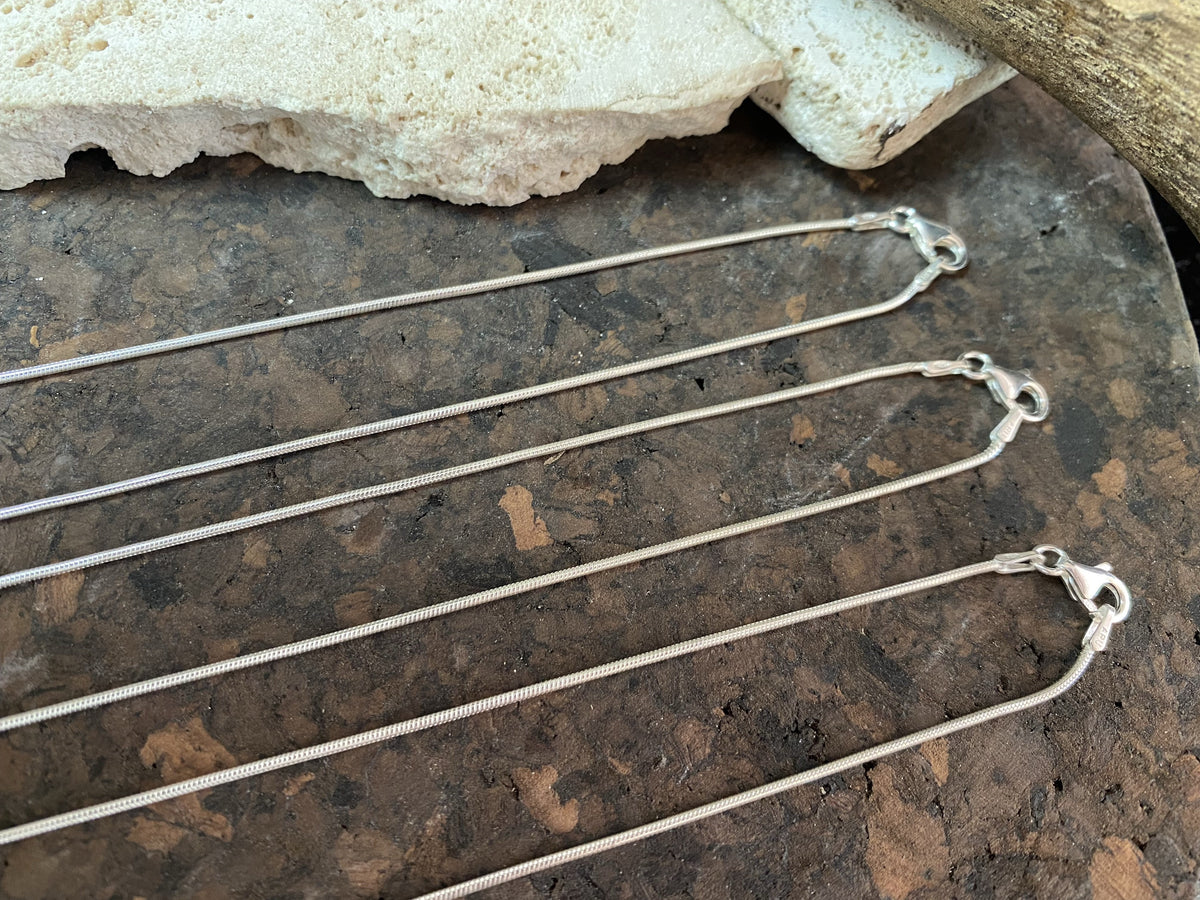 1.4 mm diameter snake chain in three lengths, these nickel-free chains are German-made from 93.5% silver and are tarnish-resistant. Our snake chain features a parrot clasp and is fitted with a narrow bail to ensure even the smallest of pendants will fit. Select Medium 45 cm/18", Long 70 cm/28" or Very long - 80 cm/32"