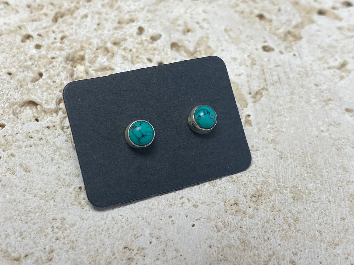 Small natural turquoise earring studs are hand made from sterling silver and set with turquoise cabochons. A unisex earring