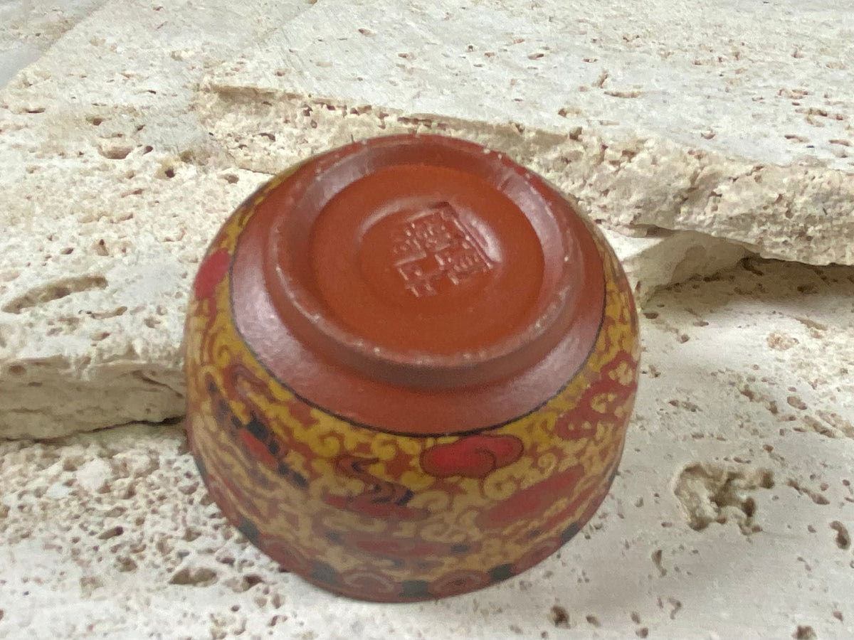 These tiny tea bowls are made from fired clay, glazed on the inside and beautifully decorated on the outside with a pattern of cloud spandrels. Stamped with the makers mark on the base. From Nepal.  As well as tea bowls, these make beautiful miniature offering bowls and when filled with sand, are perfect for holding incense sticks in the Chinese style.  Measurements: 3 cm height, diameter at top 5 cm
