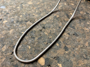 Open weave style silver snake chain, sterling silver, with a lobster claw clasp. Slightly oxidised to show the weave texture.