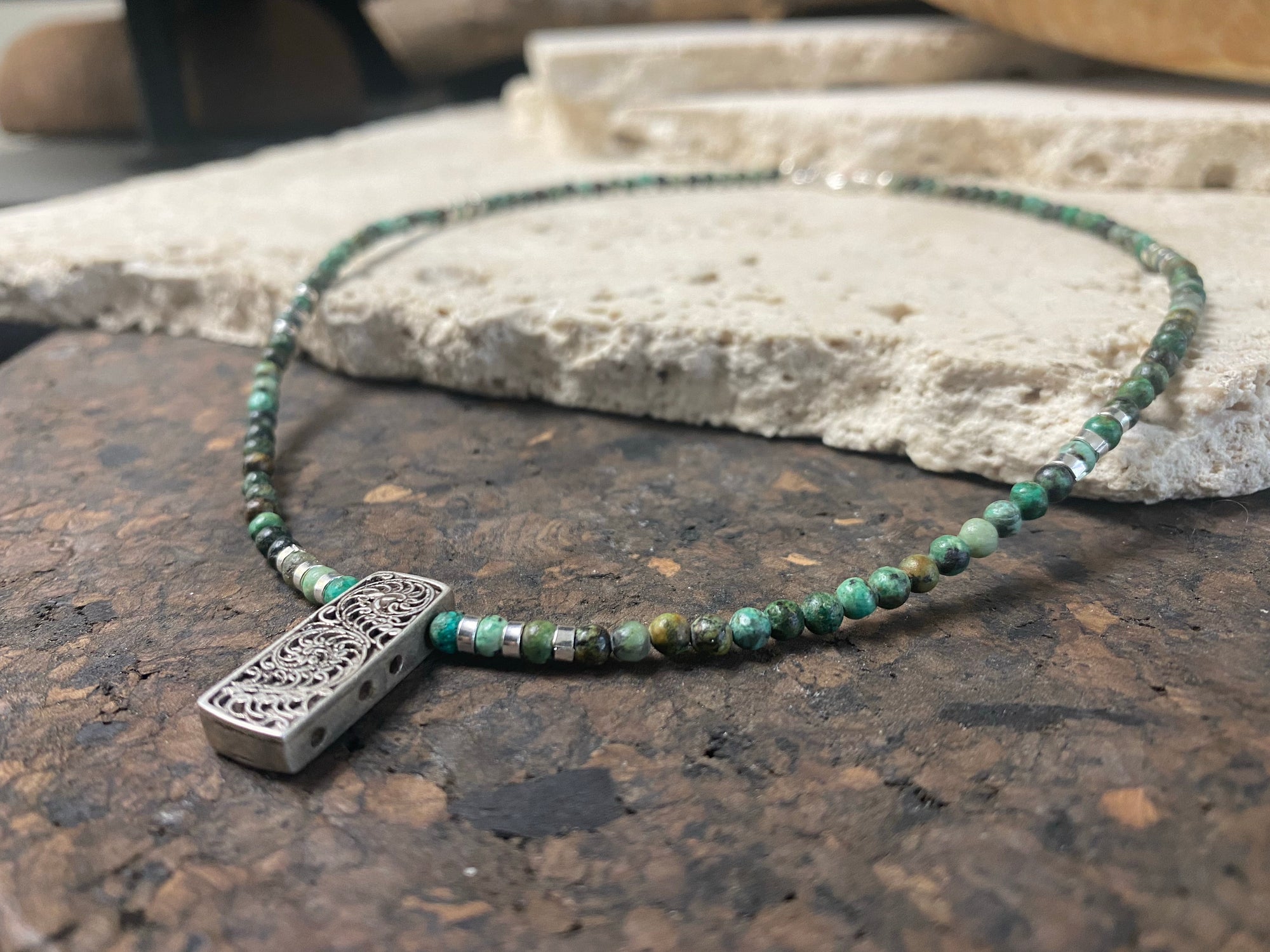 Contemporary necklace of round natural African turquoise, highlighted with sterling silver beads, a vintage Indian filigree silver pendant and sterling silver findings and clasp. Length 43.5 cm (17.25”), pendant 2.2 cm (1")